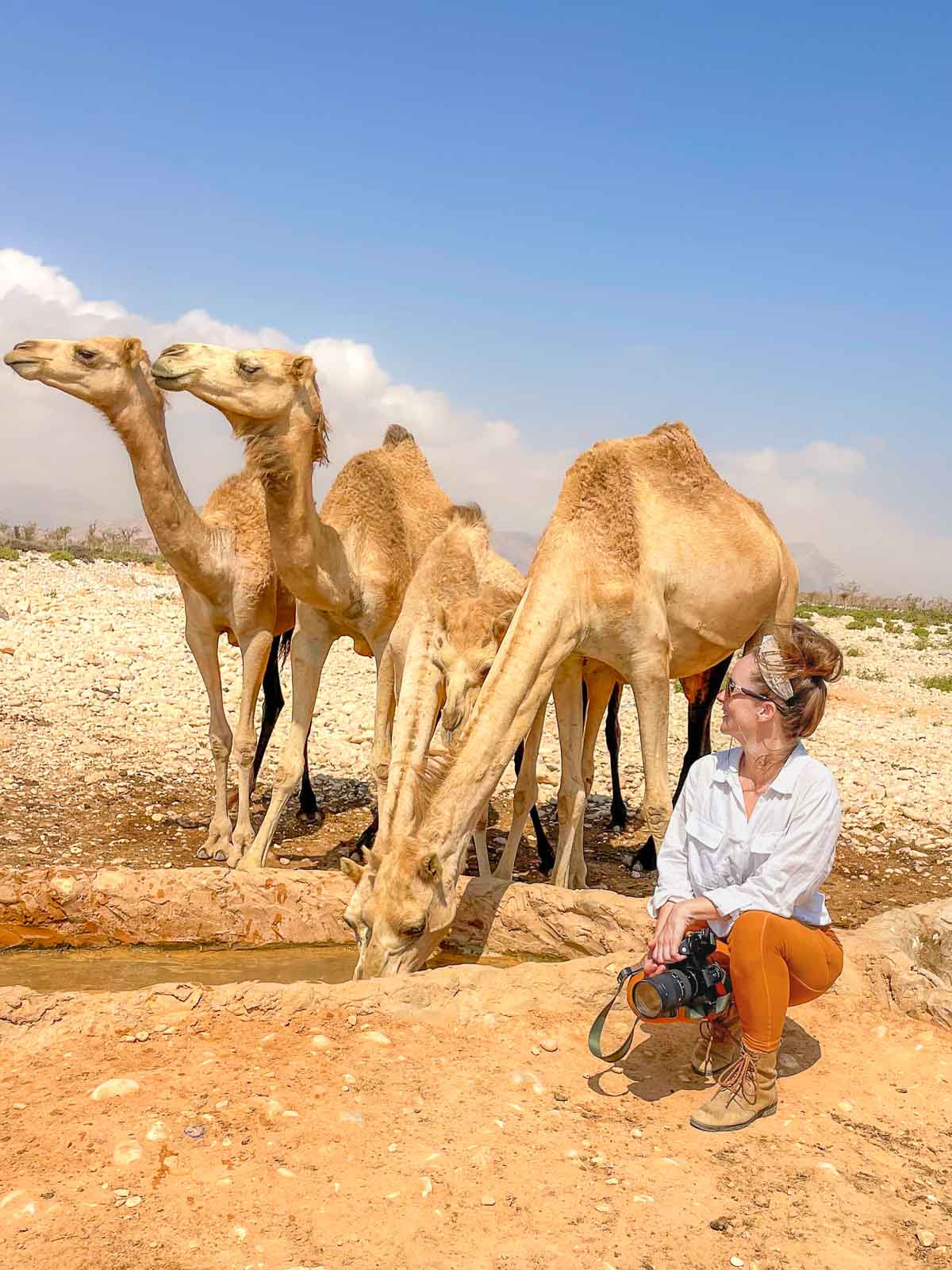 Sam in desert with camels.