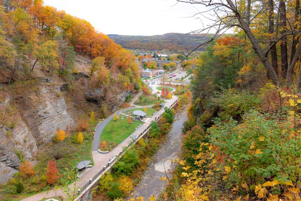 Aerial view of a pathway through a valley along a river.