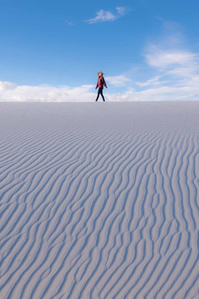Sam walking on a white sand dune in White Sands National Park.