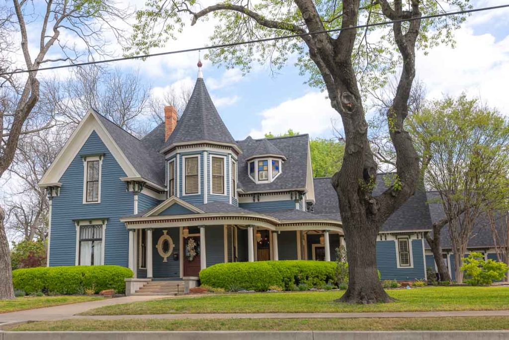 Blue Queen Anne Victorian house.