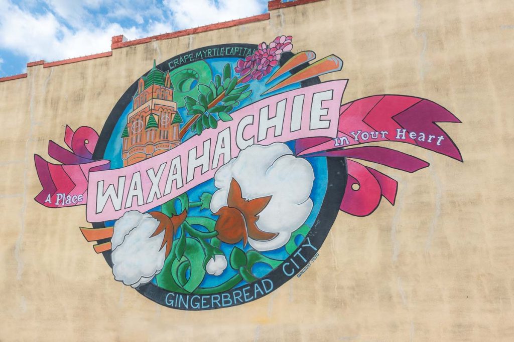 Colorful pinted town mural on a building.