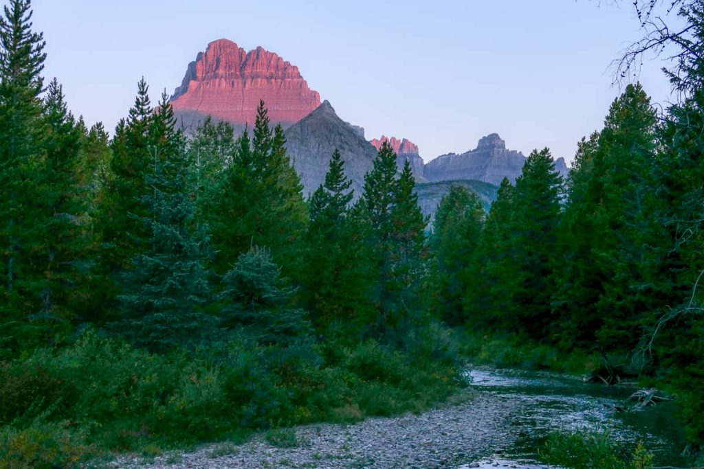 Sunrise lit mountain along a hiking trail.
