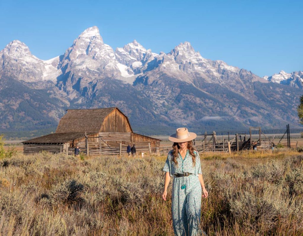 Sam walking in front of a barn in the Tetons.